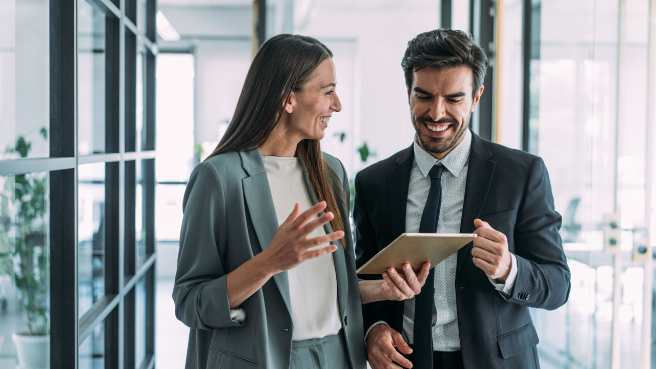 A male and female professionals talking to each other